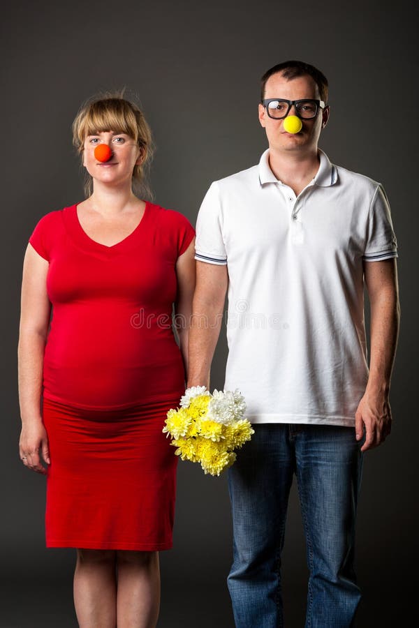 Funny couple with funny noses and bunch of flowers