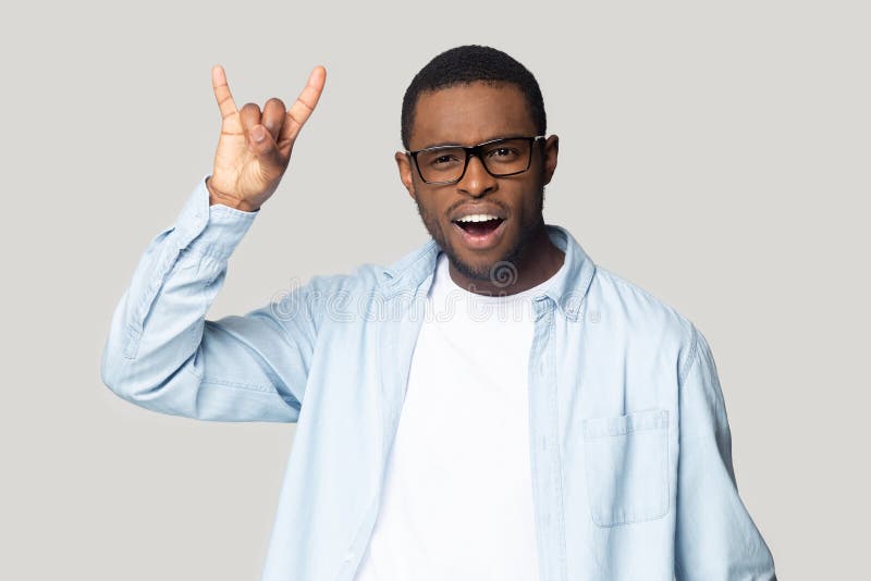 Funny crazy african american young man showing horns gesture. stock images