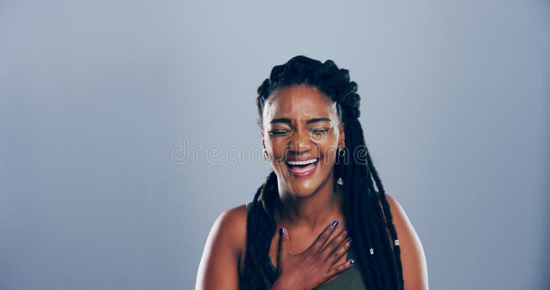 Funny, crazy and black woman laugh in studio for joke, goofy comedy and LOL isolated on gray background. Face, happy and royalty free stock image