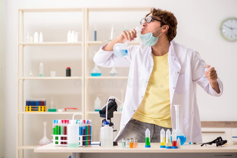 The funny crazy chemist doing experiments and tests royalty free stock photography
