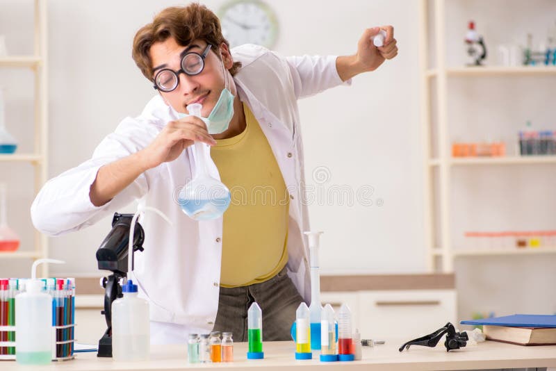 The funny crazy chemist doing experiments and tests stock photography