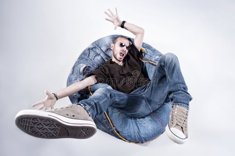 Funny crazy man dressed in jeans and sneakers royalty free stock photography