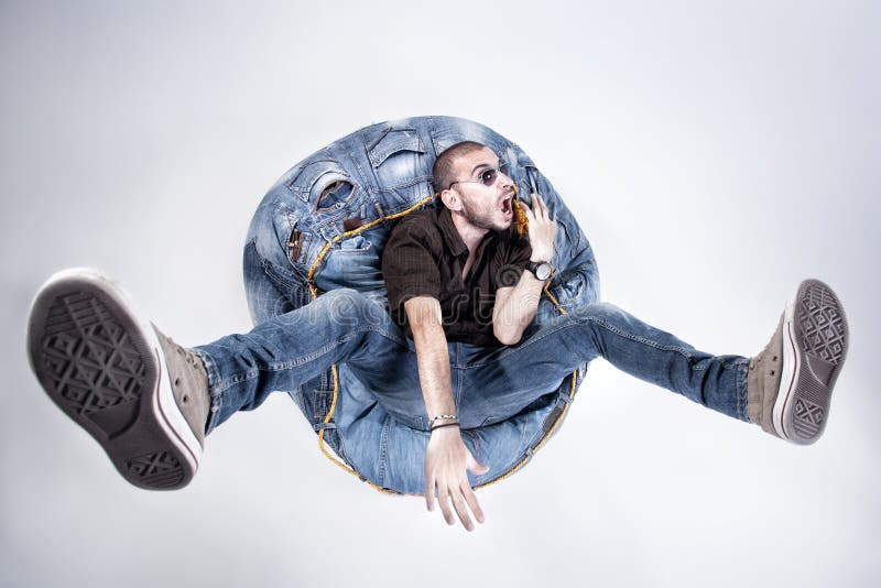 Funny crazy man dressed in jeans and sneakers royalty free stock photo