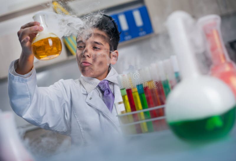 Little schoolboy working in chemistry lab. Little schoolboy working in chemistry lab