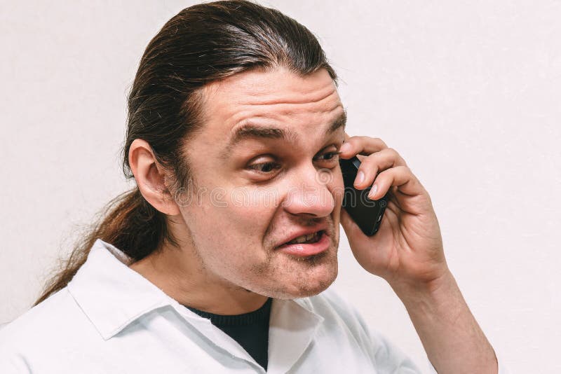 Funny crazy young man shouting at phone, expression and emotional portrait stock photos