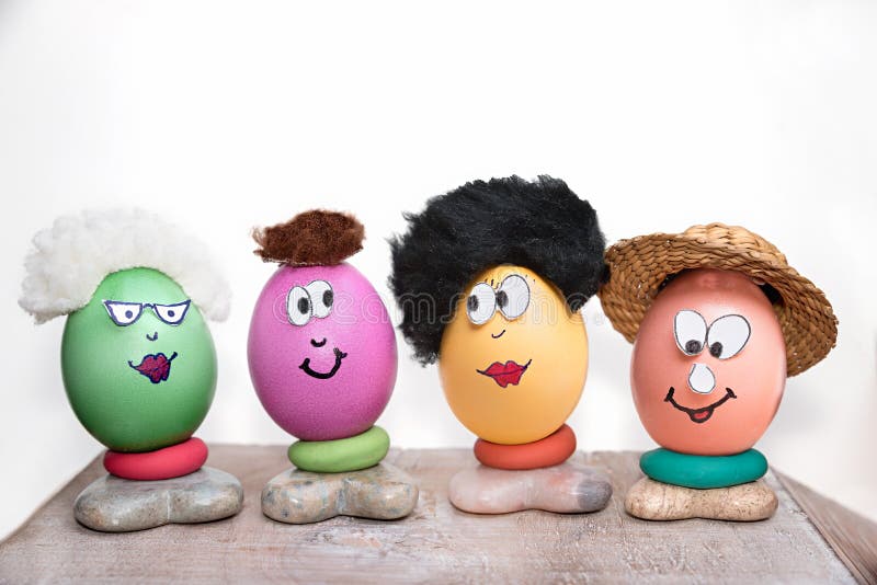 Funny easter eggs family, children handicrafts. on a wooden board, white background