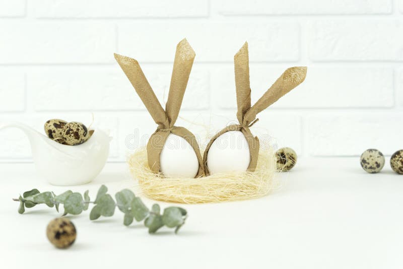 Funny Easter eggs lie in a straw nest