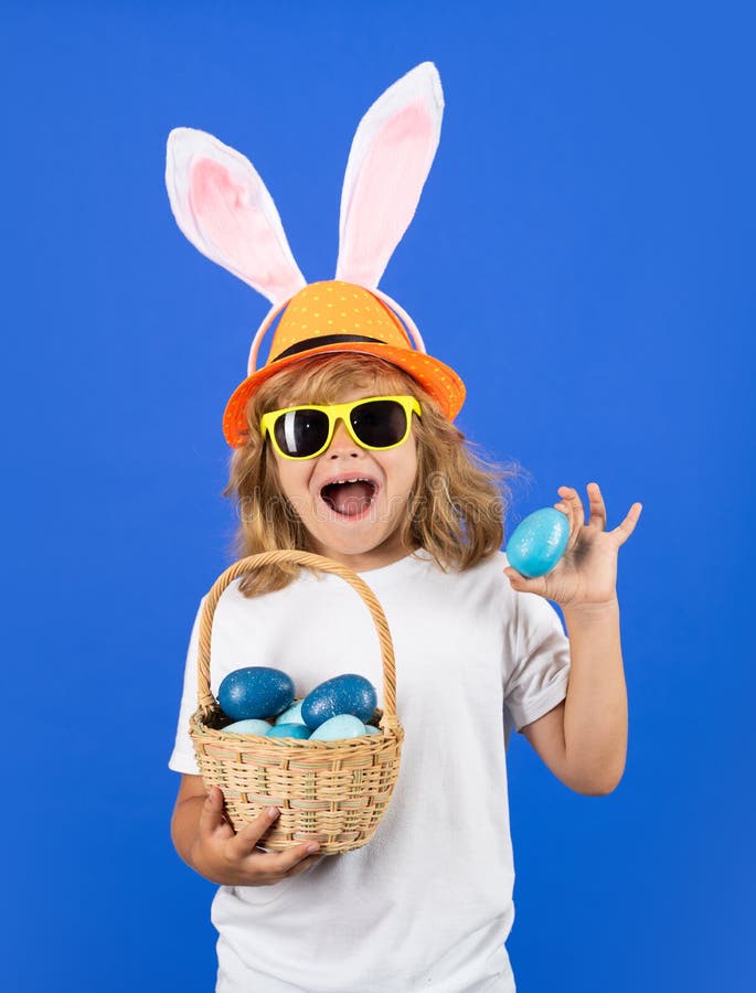 Funny Easter Kid. Happy Easter. Kid Boy with Bunny Ears Hold Easter