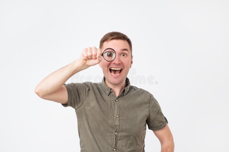 Funny european middle aged man holding magnifying glass portrait stock photo Funny european middle aged man holding magnifying glass portrait stock photo