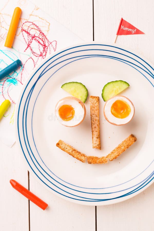 Funny Face - Kid`s Breakfast - Eggs, Toasts and Cucumber Stock Photo ...