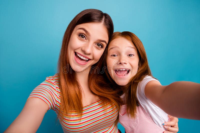 Funny foxy little lady and her mom making pretty selfies wear casual clothes isolated blue background stock photos Funny foxy little lady and her mom making pretty selfies wear casual clothes isolated blue background stock photos