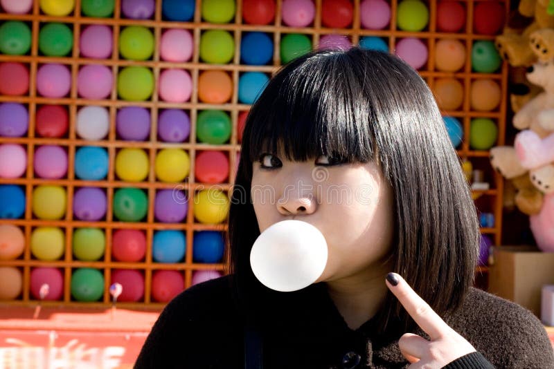 Funny girl blowing a bubble gum