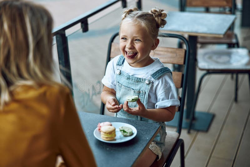 Funny girl eating cookie and smiling stock photo royalty free stock photo Funny girl eating cookie and smiling stock photo royalty free stock photo