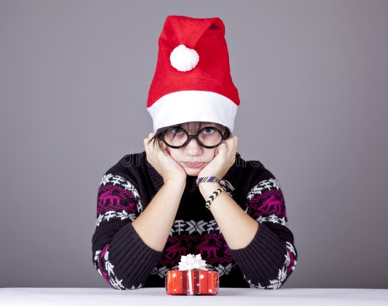 Funny girl in glasses with christmas gifts.