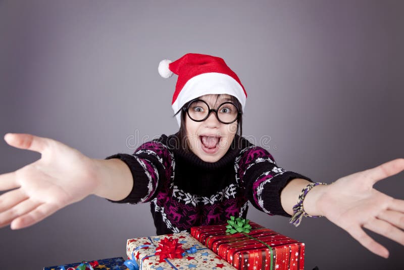 Funny girl in glasses with christmas gifts.