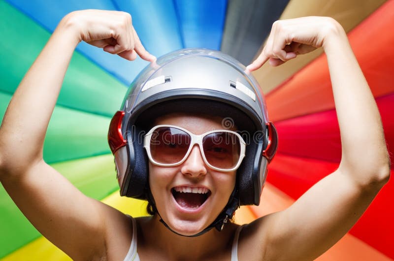 Funny Girl in Helmet Having Fun. Multicolored Background Stock Image