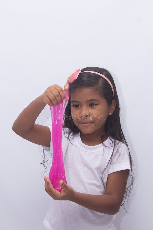 Funny girl holdin a glitter slime, photo with white background.