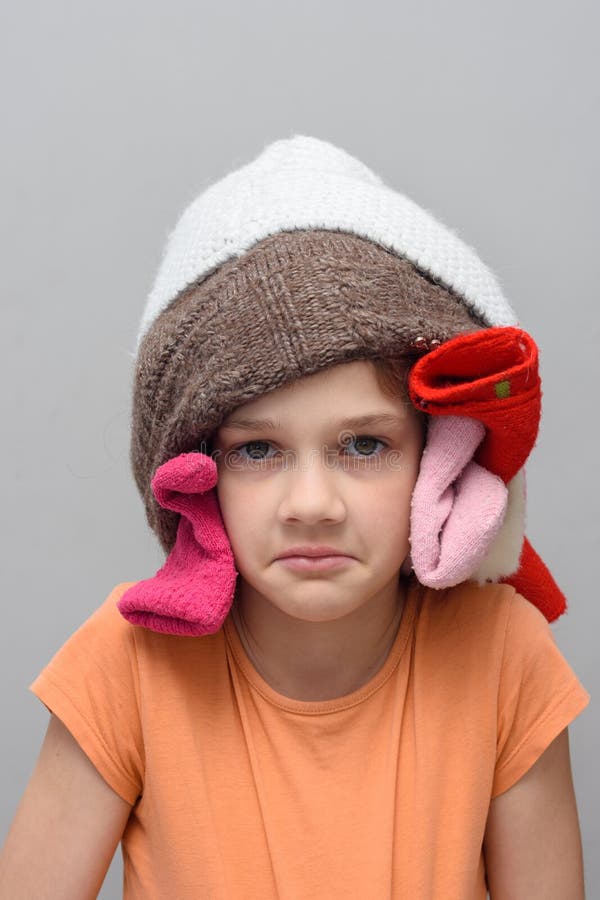 Funny Girl Put a Bunch of Things on Her Head and Looks in the Frame