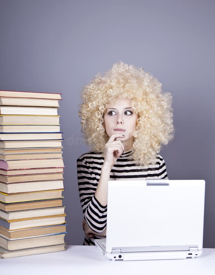 Funny girl in wig with notebook and books.