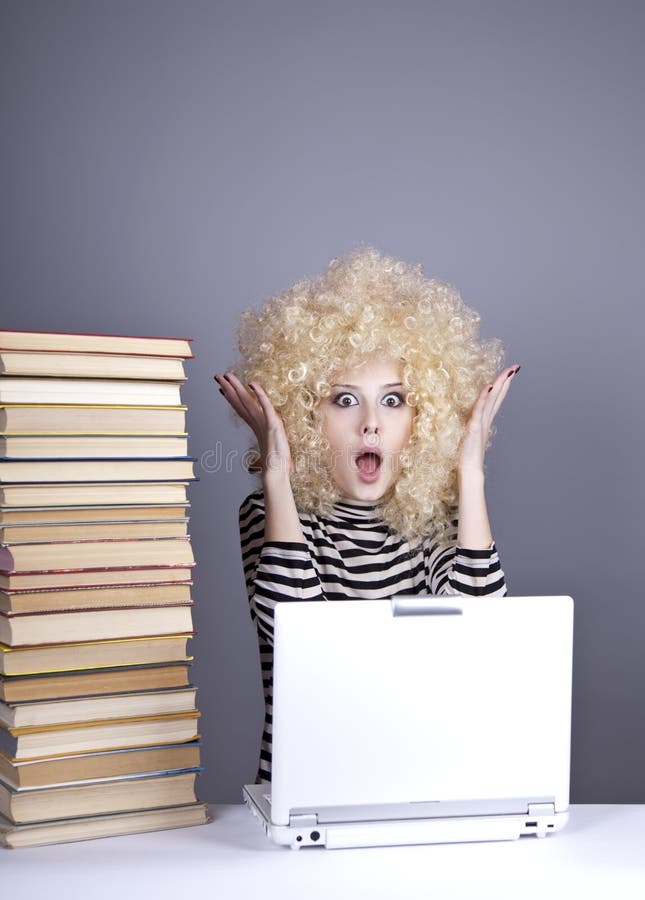 Funny girl in wig with notebook and books.