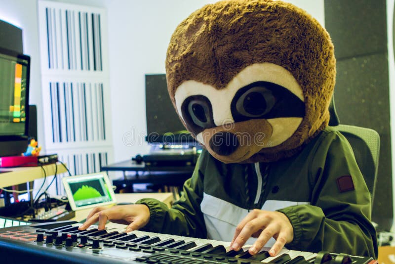Funny guy in a lemur costume is playing the piano in his studio royalty free stock images Funny guy in a lemur costume is playing the piano in his studio royalty free stock images