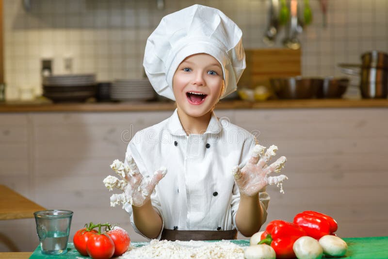 Funny happy chef boy cooking at restaurant kitchen