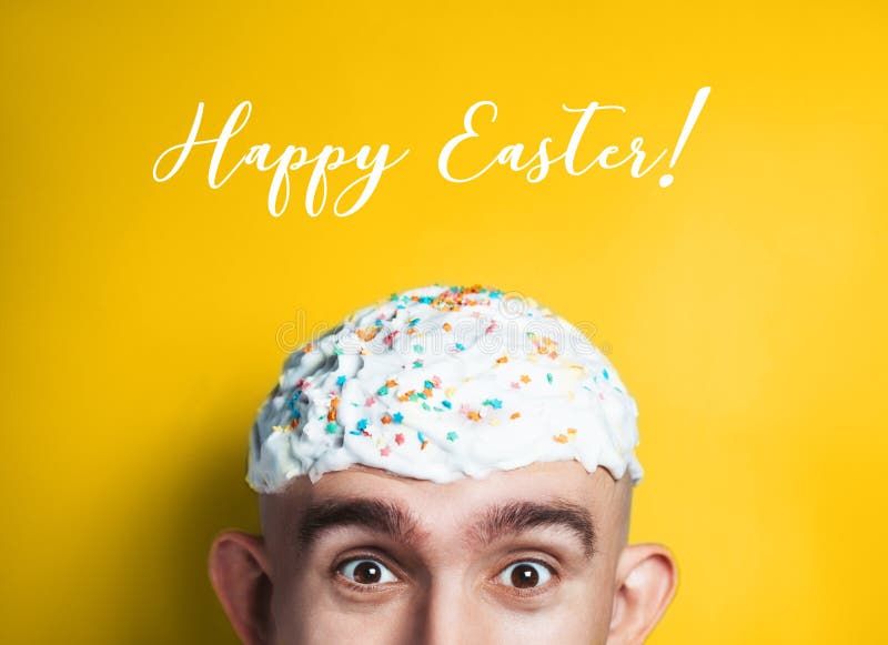 Emotional portrait of surprised bald man with easter cake on his head. Funny Easter concept.