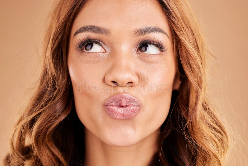 Funny, happy and face of a pouting girl isolated on a studio background. Thinking, comic and a girl with a pout royalty free stock images