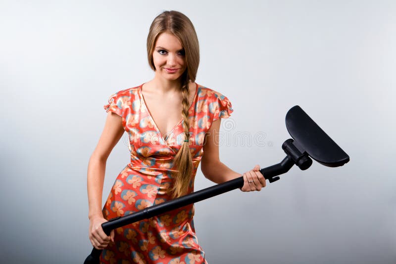 Funny housewife with vacuum cleaner