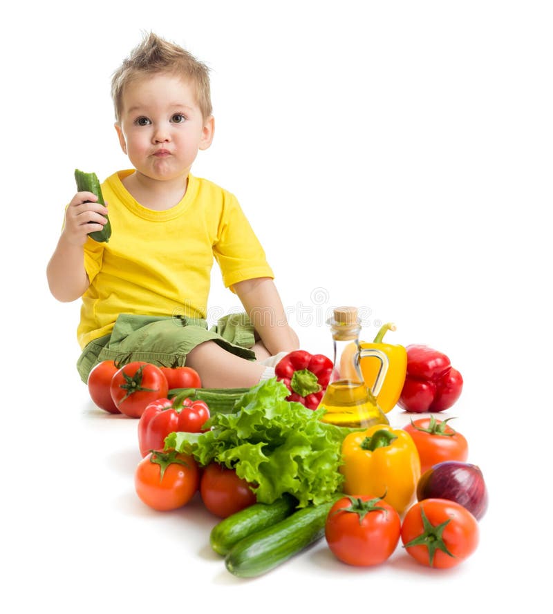 Funny kid boy eating vegetables. Healthy food. stock image Funny kid boy eating vegetables. Healthy food. stock image