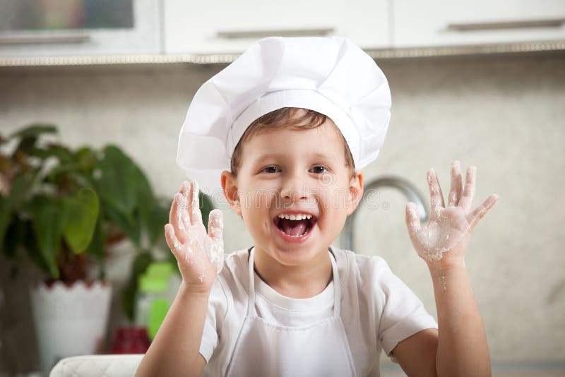 Funny baby with flour, happy emotional boy smiles happily royalty free stock image Funny baby with flour, happy emotional boy smiles happily royalty free stock image