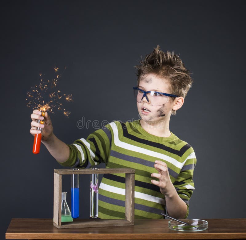 Funny little boy performing experiments. Crazy scientist. Education background.