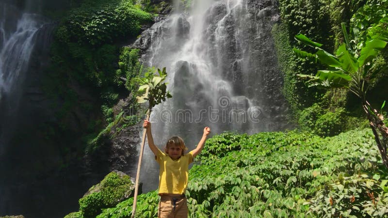 A funny little boy visits Sekumpul Waterfall, the biggest waterfall on the Bali island. Shot on a phone