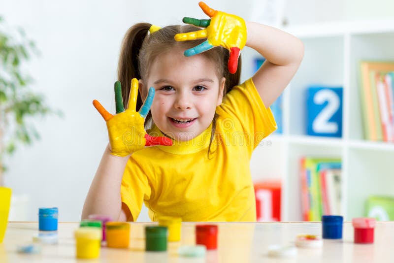 Funny little girl with hands painted in colorful royalty free stock photography Funny little girl with hands painted in colorful royalty free stock photography