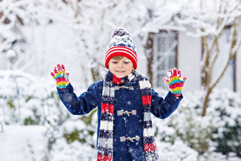 Funny Little Kid Boy in Colorful Clothes Playing Outdoors during Strong ...