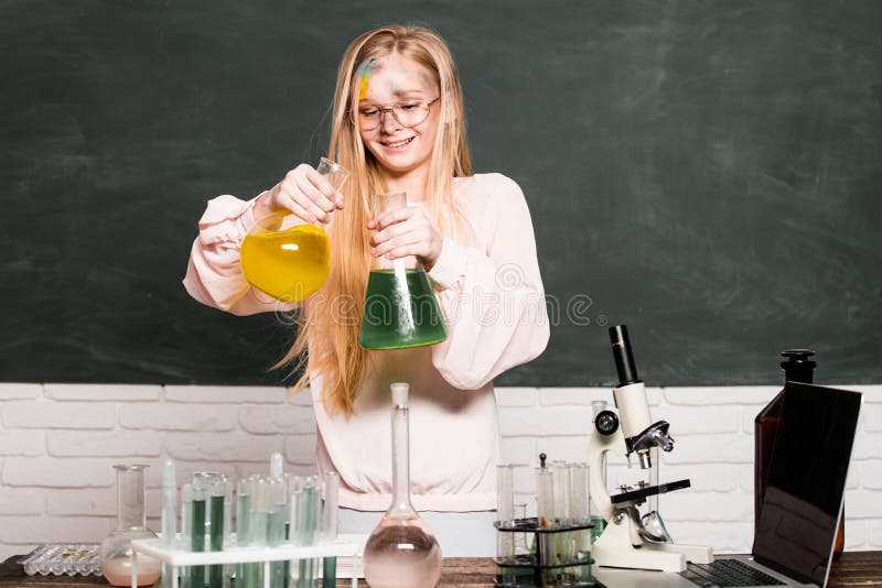 Funny little school child doing experiments in the laboratory. Science and education. Little girl scientist in the laboratory. Chemical experiment