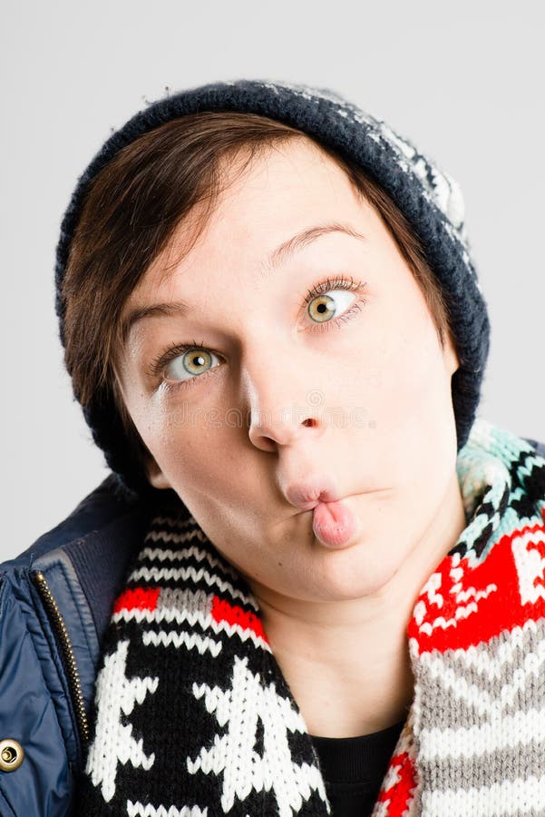 Funny woman portrait real people high definition grey background. Funny looking young woman making faces royalty free stock image Funny woman portrait real people high definition grey background. Funny looking young woman making faces royalty free stock image