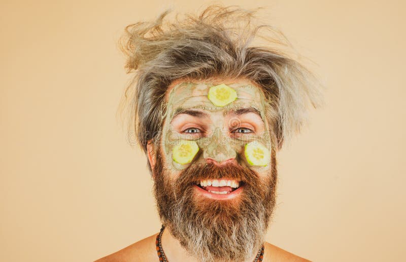 Funny Man Closeup with Clay Mask and Cucumber Slices on Face. Spa ...