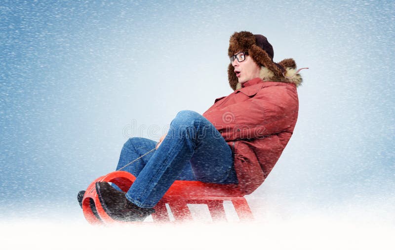 Funny man fly on a sled in the snow, concept winter fun royalty free stock images Funny man fly on a sled in the snow, concept winter fun royalty free stock images
