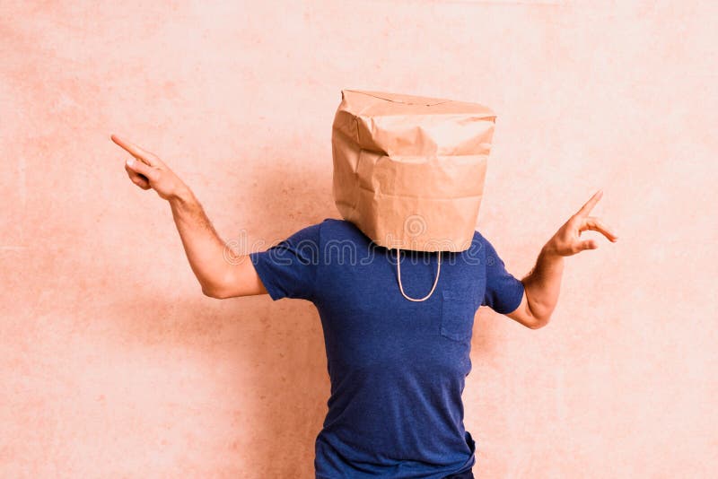 Kraft Paper Bag Is On The Mans Head Holes For Eyes Funny Idea Guy Is  Showing His Tongue Stock Photo - Download Image Now - iStock