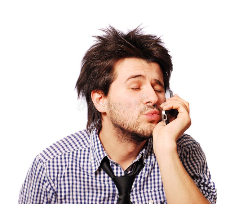 Funny cute man speaking mobile phone with his girlfriend and blowing kiss. Funny cute man speaking mobile phone with his girlfriend and blowing kiss
