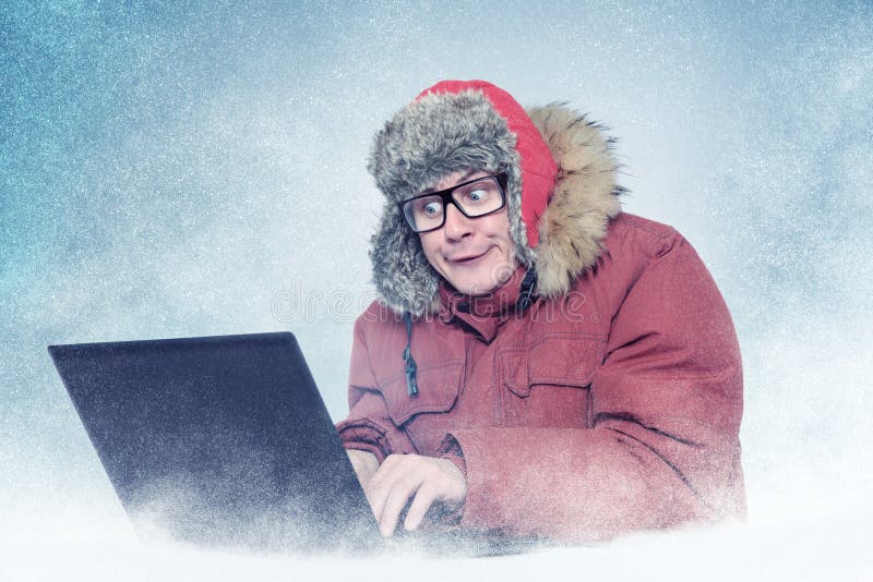 Funny Man in Winter Clothes with Laptop, Cold, Snow Stock Photo Image