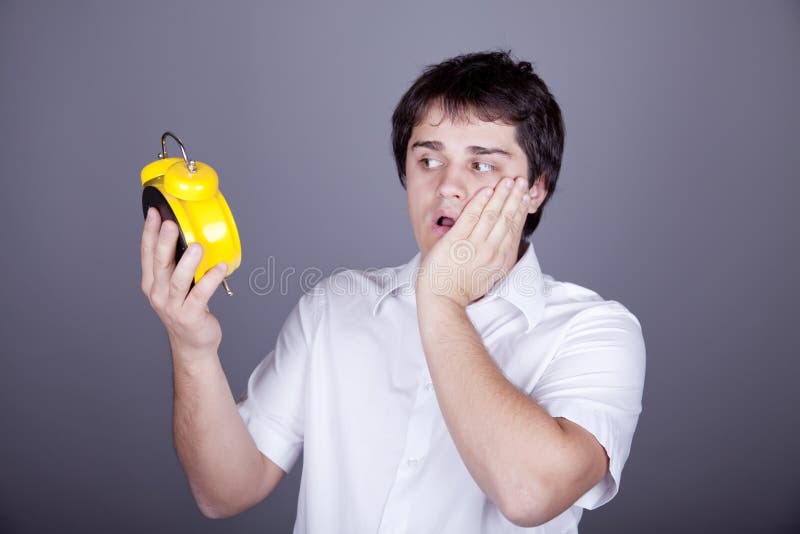 Funny men with clock. Studio shot royalty free stock photo Funny men with clock. Studio shot royalty free stock photo