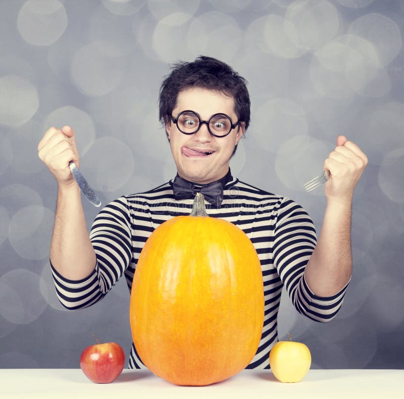 Funny Men Try To Eat a Pumpkin. Stock Photo - Image of knitted, young ...