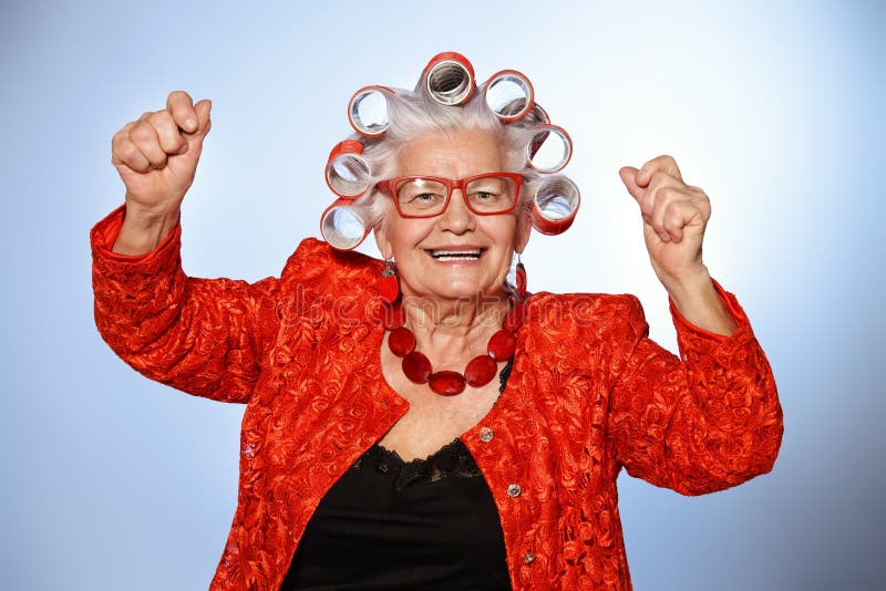 Portrait of an elderly woman in curlers looking at camera royalty free stoc...