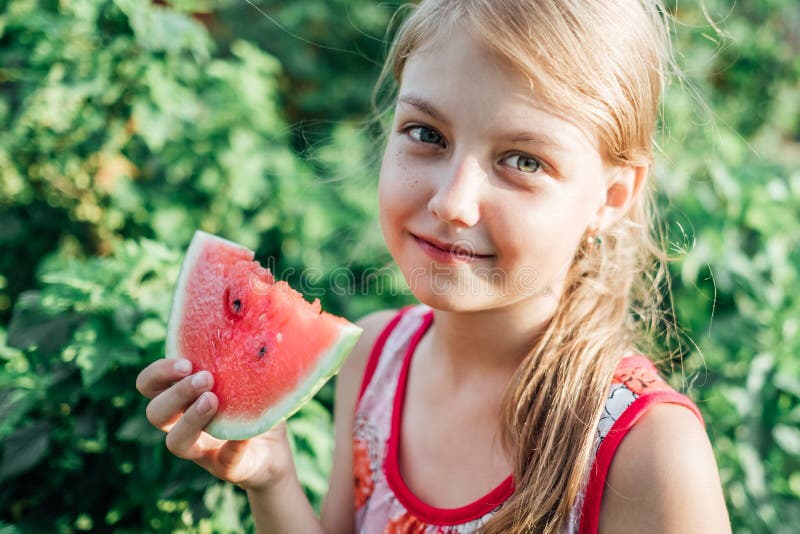 Funny portrait of adorable blonde little girl eating watermelon royalty free stock photography Funny portrait of adorable blonde little girl eating watermelon royalty free stock photography