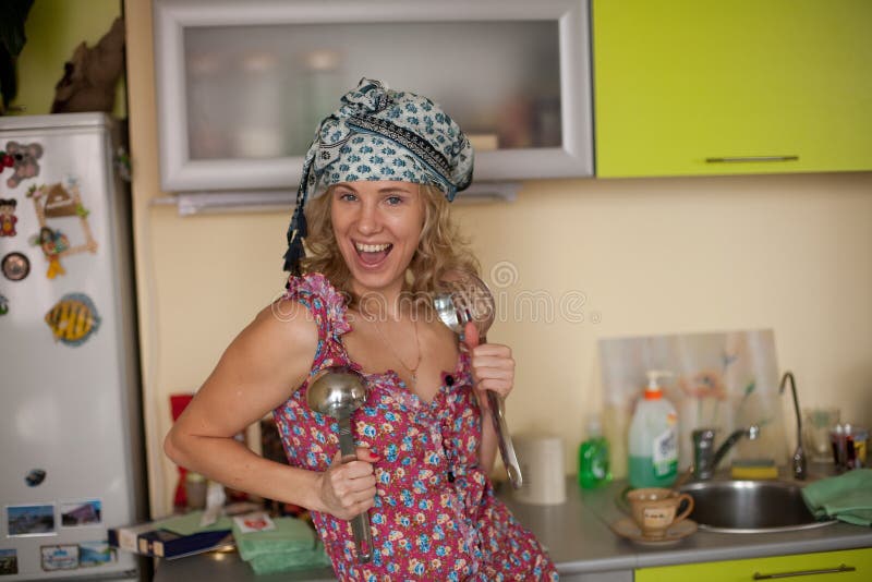 Funny portrait of the housewife in the kitchen