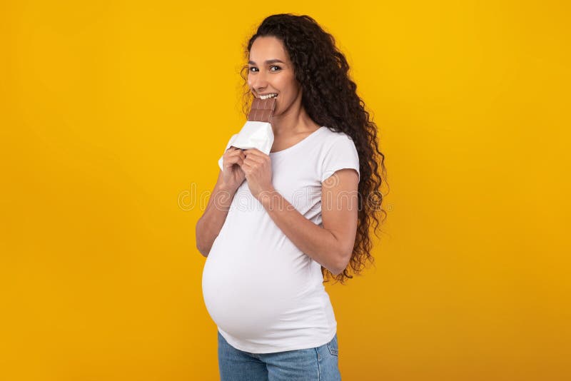 Funny Pregnant Lady Holding Chocolate At Studio