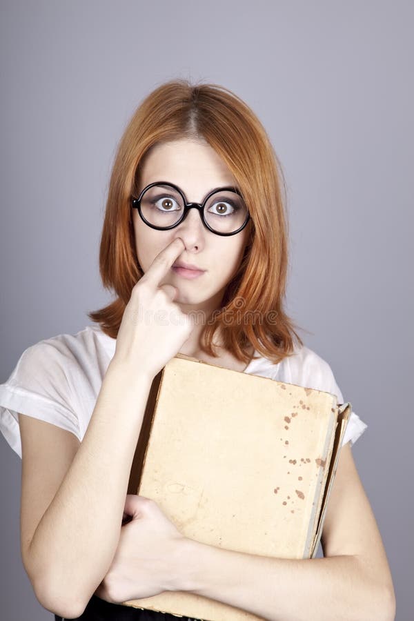 Funny red-haired girl with old book.