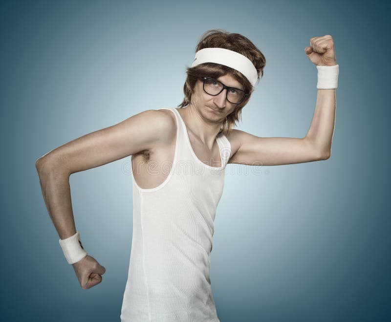 Funny retro sports nerd flexing his muscle over blue background. Funny retro sports nerd flexing his muscle over blue background